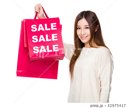 Young Woman hold with shopping bag showing three sale word 32975417