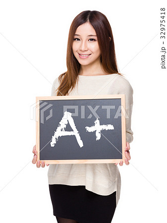 Woman hold with chalkboard showing sign of A plus Woman hold with chalkboard showing sign of A plus 32975418