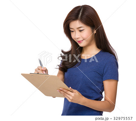 Woman take note on file board Woman take note on file board 32975557