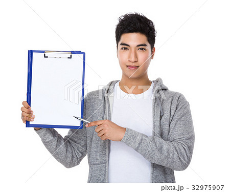 Asian man pen point to blank page of clipboard 32975907