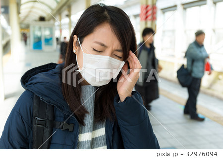 Woman feeling unwelling in train station 32976094