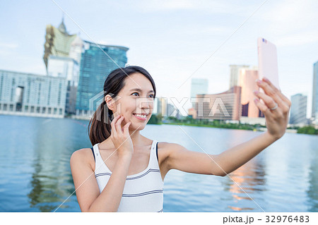 Woman taking cellphone in Macau Woman taking cellphone in Macau 32976483