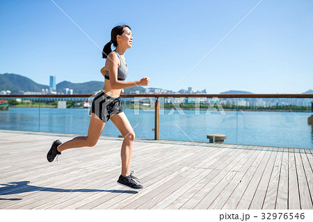 Young Woman jogging on the boardwalk 32976546