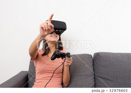 Woman play game with VR device and joystick Woman play game with VR device and joystick 32976603