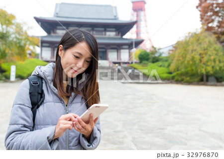 Woman use of mobile phone in Tokyo city 32976870