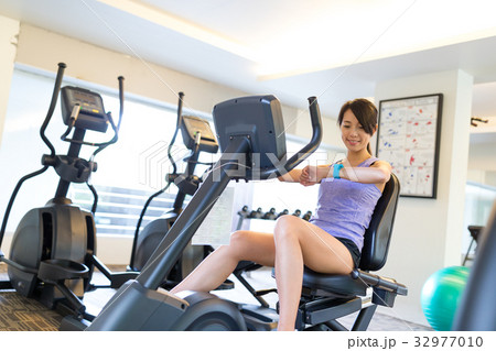 Woman cycling in gym 32977010