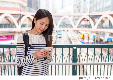Woman checking on smartphone in Hong Kong Woman checking on smartphone in Hong Kong 32977107