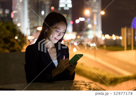 Business woman working on cellphone in Hong Kong city 32977178
