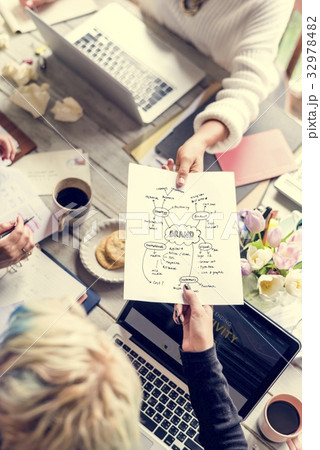 Colleagues Handing Branding Plan Strategy to other Colleagues Handing Branding Plan Strategy to other 32978482