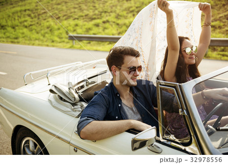 Couple Driving a Car Traveling on Road Trip Together 32978556