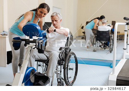 Positive delighted woman standing near her patient Positive delighted woman standing near her patient 32984617