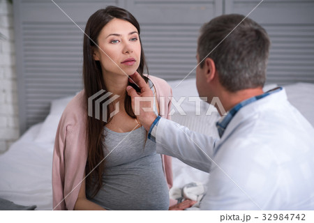 Concentrated pregnant woman being at consultation Concentrated pregnant woman being at consultation 32984742