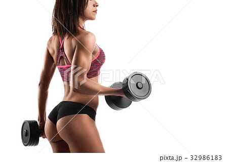 Athletic woman working out with dumbbells 32986183