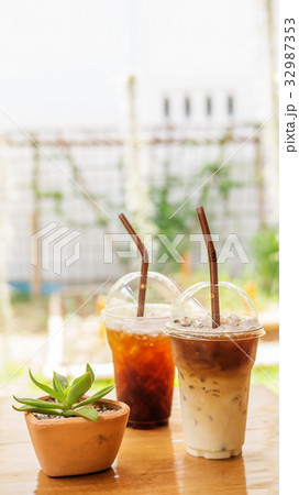 iced latte and americano coffee on a wooden table. 32987353