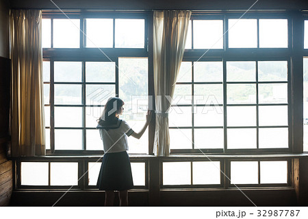 教室 窓を開ける女子高生の写真素材