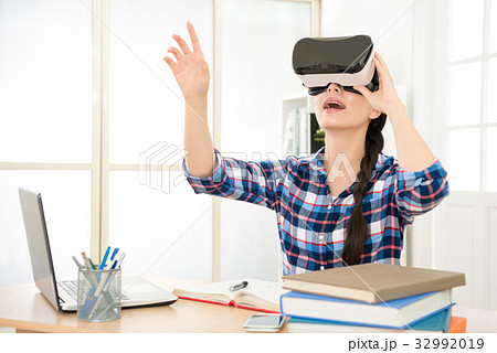 woman wearing virtual reality glasses woman wearing virtual reality glasses 32992019