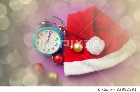 Christmas alarm clock and Santas hat Christmas alarm clock and Santas hat 32992591
