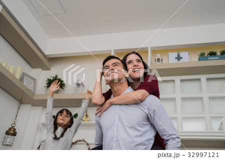 .This family is smiling happily in the house. .This family is smiling happily in the house. 32997121