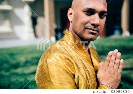 Indian Man Namaste in Gold Kurta at the Temple Indian Man Namaste in Gold Kurta at the Temple 32999350