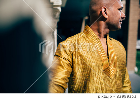 Handsom Indian Man in Gold Kurta at the Temple 32999353