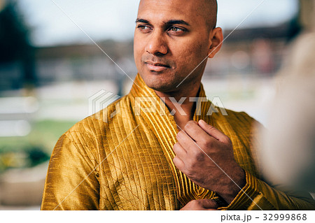 Handsom Indian Man in Gold Kurta at the Temple 32999868