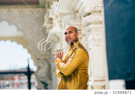 Handsom Indian Man in Gold Kurta at the Temple 32999871