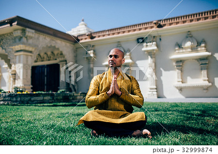 Indian Man Greeting Namaste in Gold Kurta atTemple 32999874