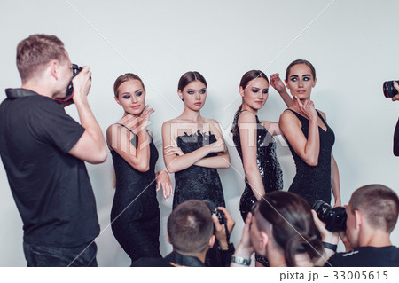 Photographers paparazzi take photos of women in 33005615
