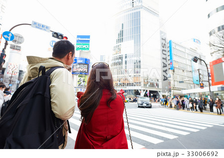 a picture of a woman and her husband standing on the street 33006692