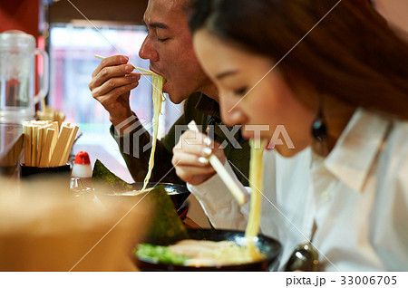 A man and his wife are eating ramen A man and his wife are eating ramen 33006705