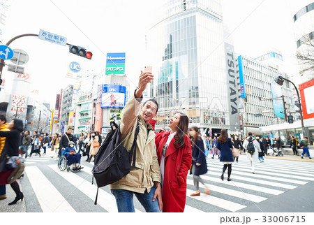 A couple is taking selfies on the street A couple is taking selfies on the street 33006715