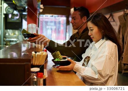the man and the woman are holding the bowls of food the man and the woman are holding the bowls of food 33006721