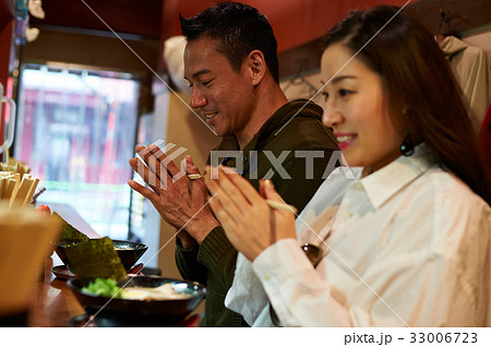 two people are praying together before they eat two people are praying together before they eat 33006723