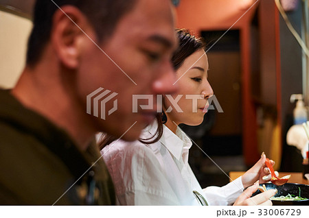 the girl is eating something near the man 33006729