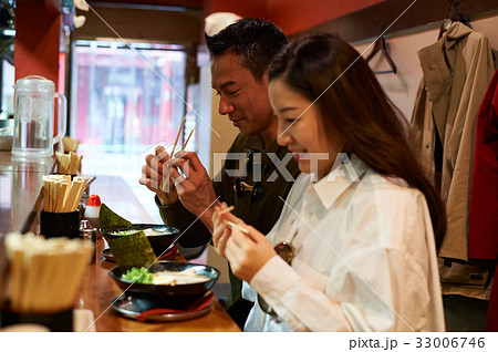 a couple is holding chopsticks and preparing to eat a couple is holding chopsticks and preparing to eat 33006746