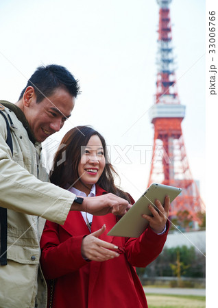a couple is using tablet and smiling a couple is using tablet and smiling 33006766