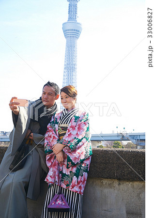 A medium-aged couple is taking selfie near skytree tower A medium-aged couple is taking selfie near skytree tower 33006827