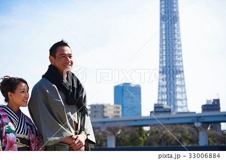happy couple in kimono is looking at something outdoors 33006884