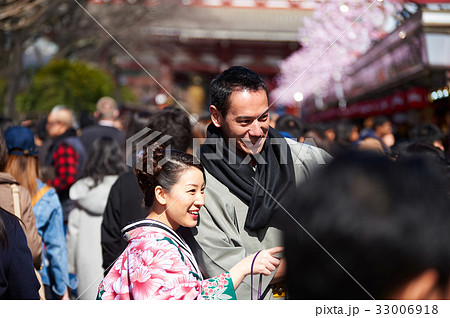 A happy couple wearing kimono is excited about something at downtown 33006918