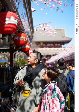 A happy couple wearing kimono is looking at something at downtown in japan 33006931