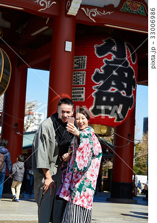 A portrait of a couple taking selfie in front of the temple in the morning. A portrait of a couple taking selfie in front of the temple in the morning. 33006986