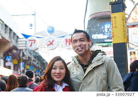 a photo of a couple smiling and looking at camera. 33007027