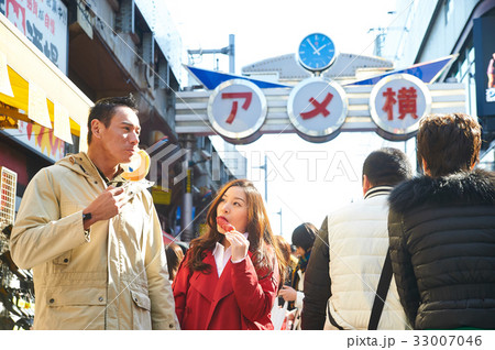 a woman is looking at a man while he is looking at something. a woman is looking at a man while he is looking at something. 33007046