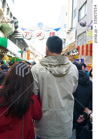 a photo of a couple walking on a street. a photo of a couple walking on a street. 33007054