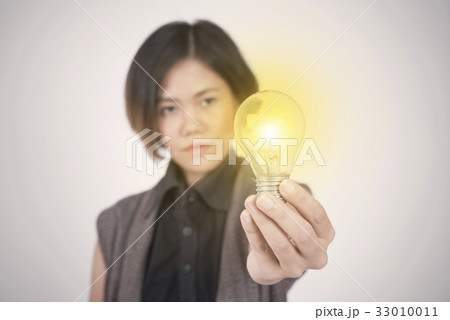 Business women hand holding light bulb. Business women hand holding light bulb. 33010011
