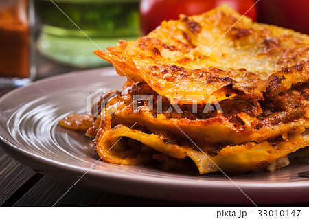 Piece of tasty hot lasagna on a plate 33010147