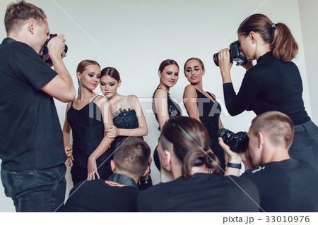 Photographers paparazzi take photos of women in 33010976