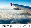 Wing of the plane on blue sky and mountains 33012883