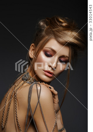beautiful girl with many golden and bronze chains beautiful girl with many golden and bronze chains 33014543