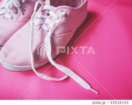 Sneakers on pink background 33016143